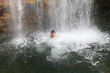 Rainbow, waterfall and swimming person