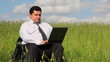 Businessman sitting outdoors using laptop