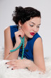 Closeup beautiful glamour woman on white fur. Beads Closeup beautiful glamour woman on white fur. Beads