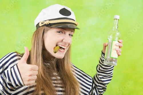 Photo: female sailor with bottle of vodka and pickle female sailor with bottle of vodka and pickle