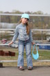 girl in jeans sitting on fence