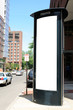Tall billboard on telephone booth