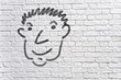 Head graffiti on a white brick wall