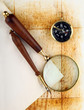 Compass and magnifier  on old textured paper
