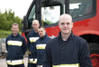 Group of firefighters by fire engine