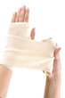 Woman wrapping her hand with a bandage on a white background