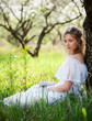 woman in white dress sitting on grass