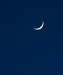 A crescent moon hanging in the night sky A crescent moon hanging in the night sky