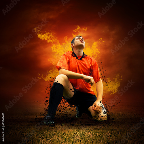 Photo: Football player in fires flame on the outdoors field Football player in fires flame on the outdoors field