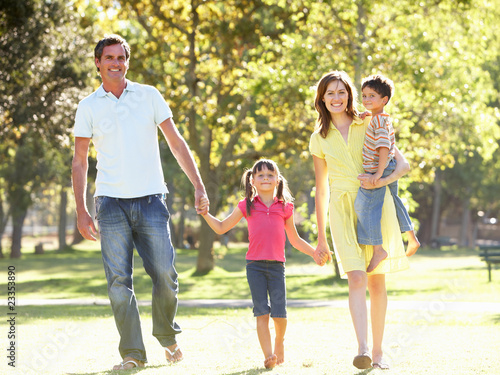 Photo: Family Enjoying Walk In Park Family Enjoying Walk In Park