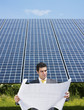 Photo: businessman standing near solar panels businessman standing near solar panels