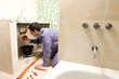 Plumber fixing pipes