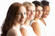 Portrait Of Four Attractive Young Women In Studio Standing In Li