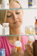 Woman Looking in Medicine Cabinet