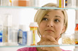 Woman Looking in Medicine Cabinet