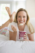 Foto: Woman Eating Ice Cream in Bed Woman Eating Ice Cream in Bed