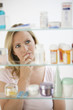 Photo: Woman Looking in Medicine Cabinet Woman Looking in Medicine Cabinet
