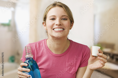 Photo: Woman Holding Mouthwash Woman Holding Mouthwash