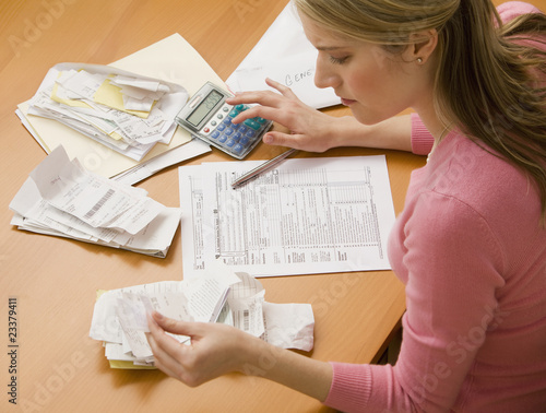 Photo: Woman Paying Bills Woman Paying Bills