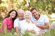 Senior Couple With Grown Up Children In Park