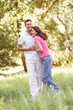 Portrait Of Young Couple Walking In Park
