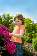 little girl 3 years old with peony flowers