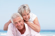 Senior Couple Relaxing On Beach Holiday