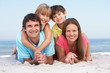 Photo: Family Relaxing On Beach Holiday Family Relaxing On Beach Holiday
