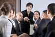Photo: Diverse businesspeople conversing, woman at front Diverse businesspeople conversing, woman at front