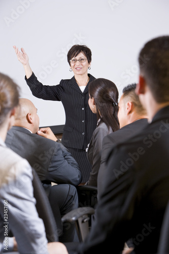 Photo: Hispanic woman speaking to group of businesspeople Hispanic woman speaking to group of businesspeople