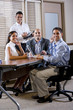 Happy office workers meeting at table in boardroom Happy office workers meeting at table in boardroom