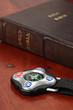 Compass and the Holy Bible in background