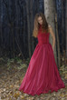 girl leaning against a tree in the twilight forest
