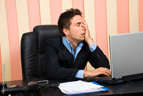 Photo: Stressed business man with problems at laptop Stressed business man with problems at laptop