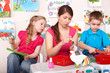 Child with teacher in play room.