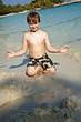 boy plays at the  beach with sand and building figures