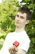 Man's hands gifting heart on holiday day