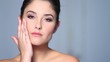 Beautiful young woman applaying cosmetics