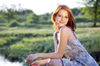 red-haired girl in the village at sunset