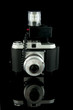 old fashioned photocamera over black background