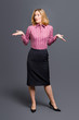 Striped shirt woman shrugging shoulders