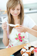 Photo: Portrait of a beautiful woman preparing a cake in the kitchen Portrait of a beautiful woman preparing a cake in the kitchen