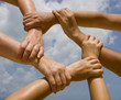 Many hands connecting to a chain with sky Many hands connecting to a chain with sky