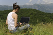 Young beautiful woman using her notebook in the nature Young beautiful woman using her notebook in the nature
