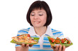 Woman makes choice of pizza and healthy salad Woman makes choice of pizza and healthy salad