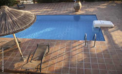 Photo: Swimming pool with deckchairs Swimming pool with deckchairs