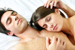 Young beautiful couple sleeping in bed