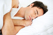 Foto: Closeup of a young man sleeping on the bed Closeup of a young man sleeping on the bed