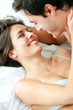 Young couple enjoying themselves on bed