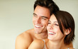 Happy young couple looking at copyspace